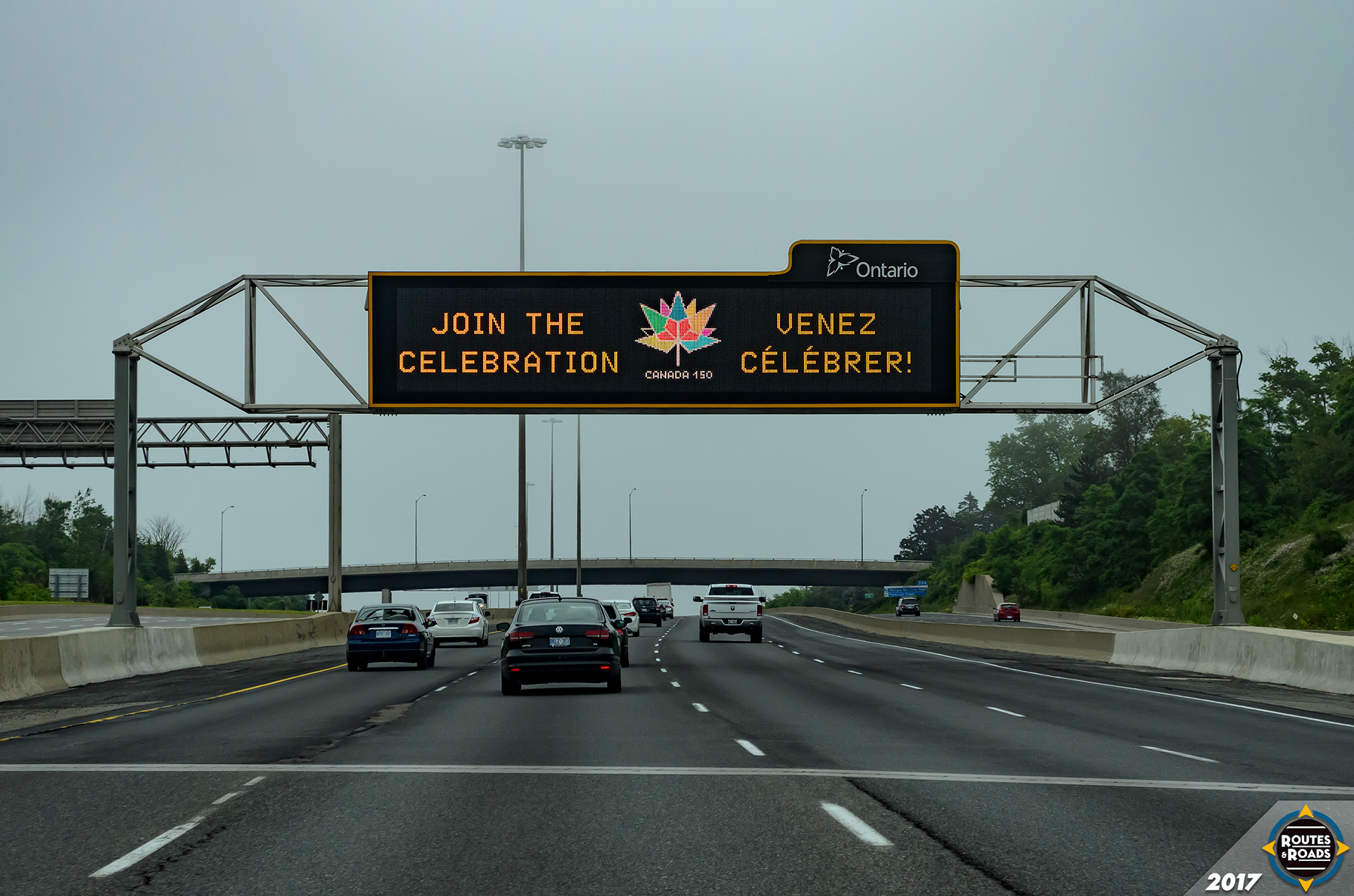An Ontario Variable Message Sign (VMS) displaying a celebratory message for Canada's 150 anniversary on the eastbound Highway 401 at Rouge Park.