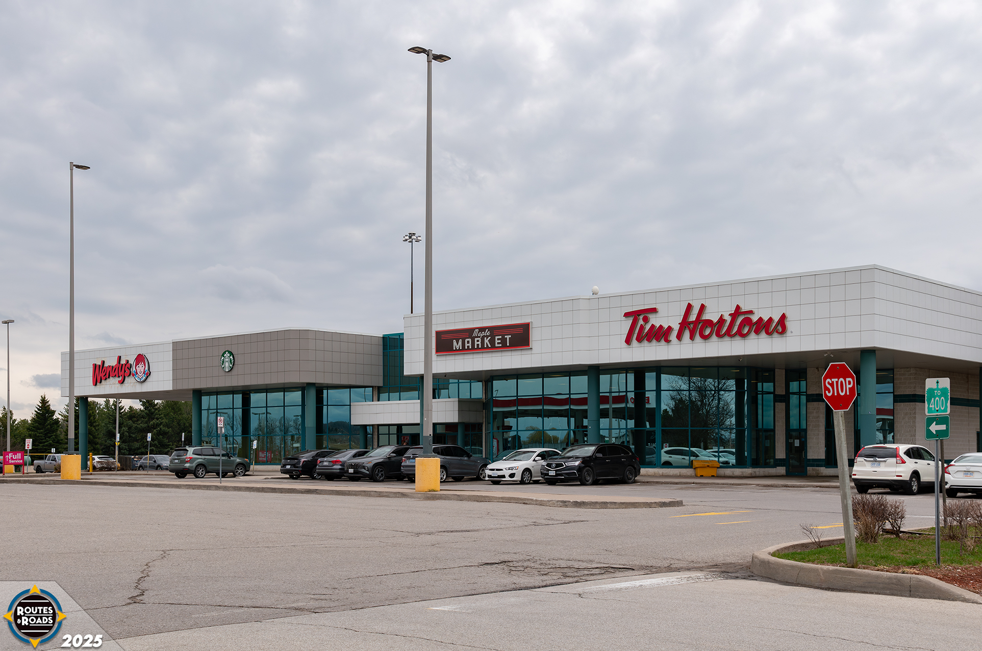 A closer view of the vintage service centre building featuring amenities and fast-food restaurants.