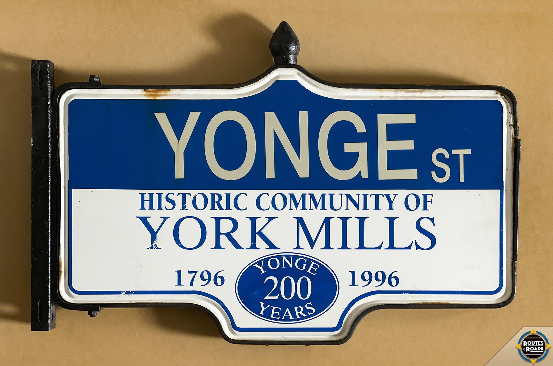 A large Rosco Acorn street sign commemorating the 200-year anniversary of Toronto's main street within the historic community of York Mills.