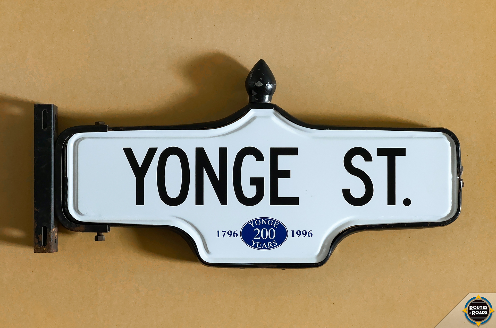 A small Rosco Acorn street sign commemorating the 200-year anniversary of Toronto's main street.